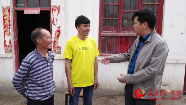 4月3日上午，阿瓦提县乌鲁却勒镇干部看望李金明（左）、图尔迪（中）父子俩。记者杨明方摄