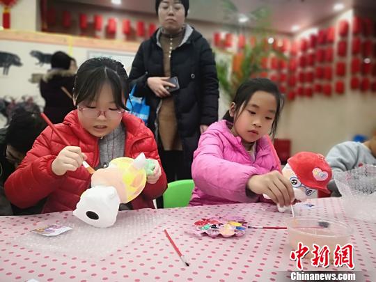 2月5日农历春节大年初一，一群8至12岁的小朋友在甘肃省博物馆参观“金猪拱福”文物展，并参与绘制小猪存钱罐亲子活动。　南如卓玛摄