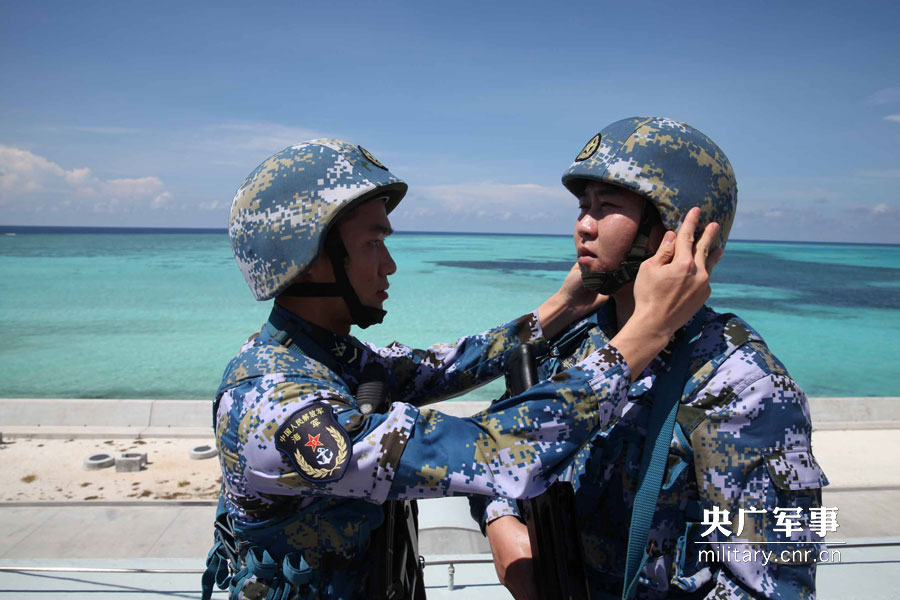 接过南沙卫士手中的钢枪，青年歌手李龙精神抖擞。梁永春摄